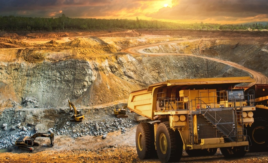 bnn1 Yellow dump truck loading minerals copper, silver, gold, and other at mining quarry.